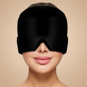 Black sleep mask worn by a person on a light gray background
